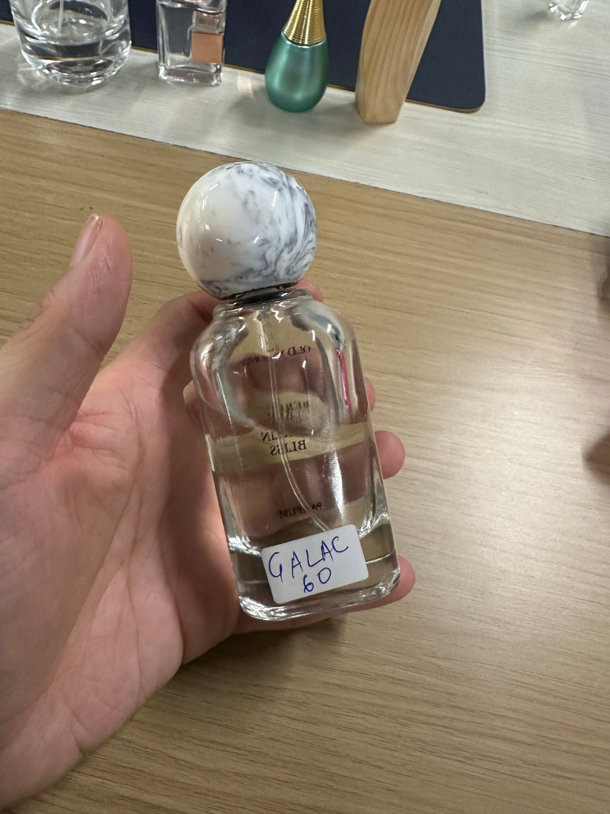 Mahtab perfume bottle — clear glass with white marble dome cap